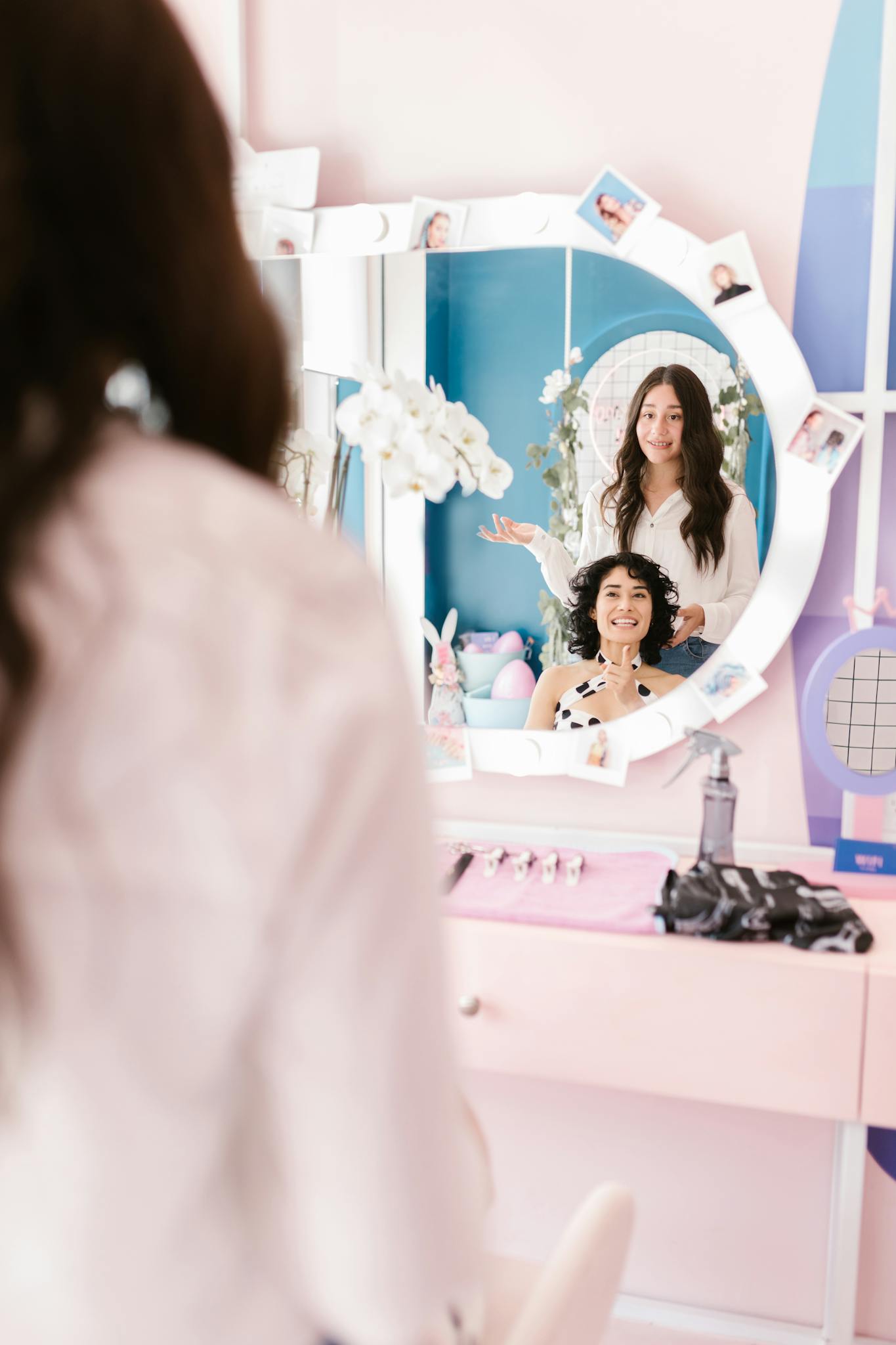 Woman having her hair styled in a chic salon setting.